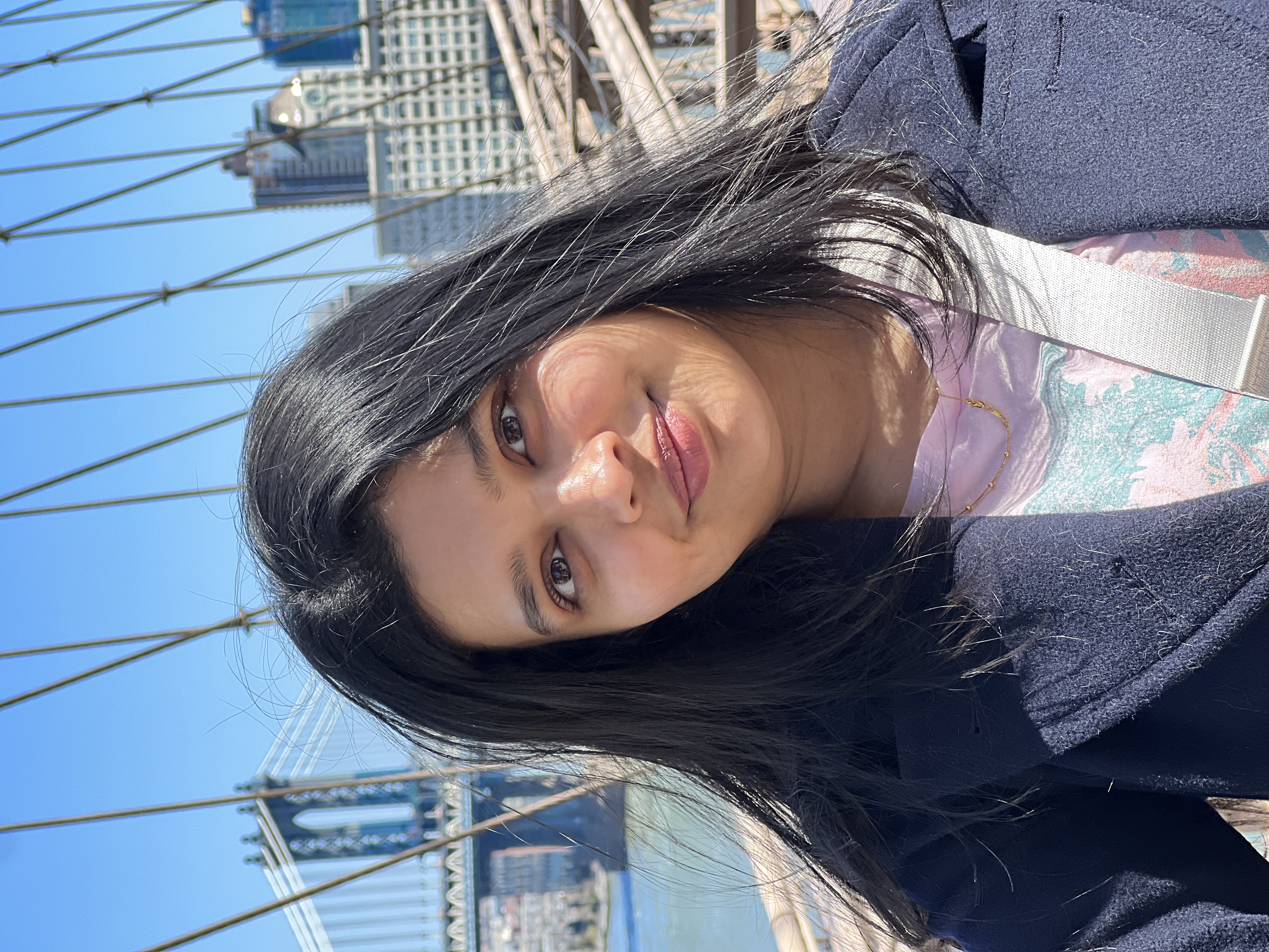 Usaila Anjum smiling on the Brooklyn Bridge